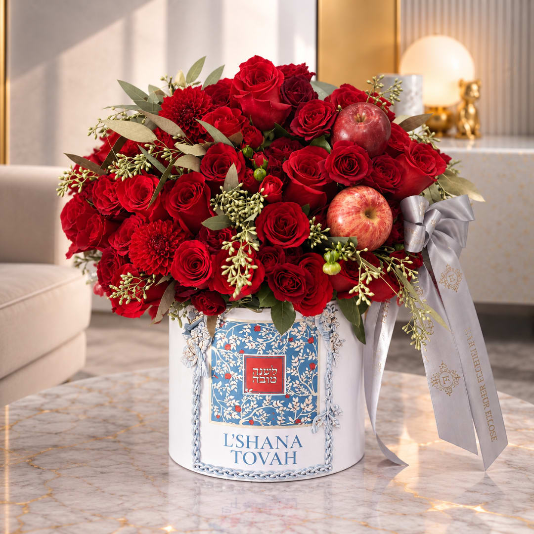 Red rose arrangement in a white gift box with apples and a silver ribbon