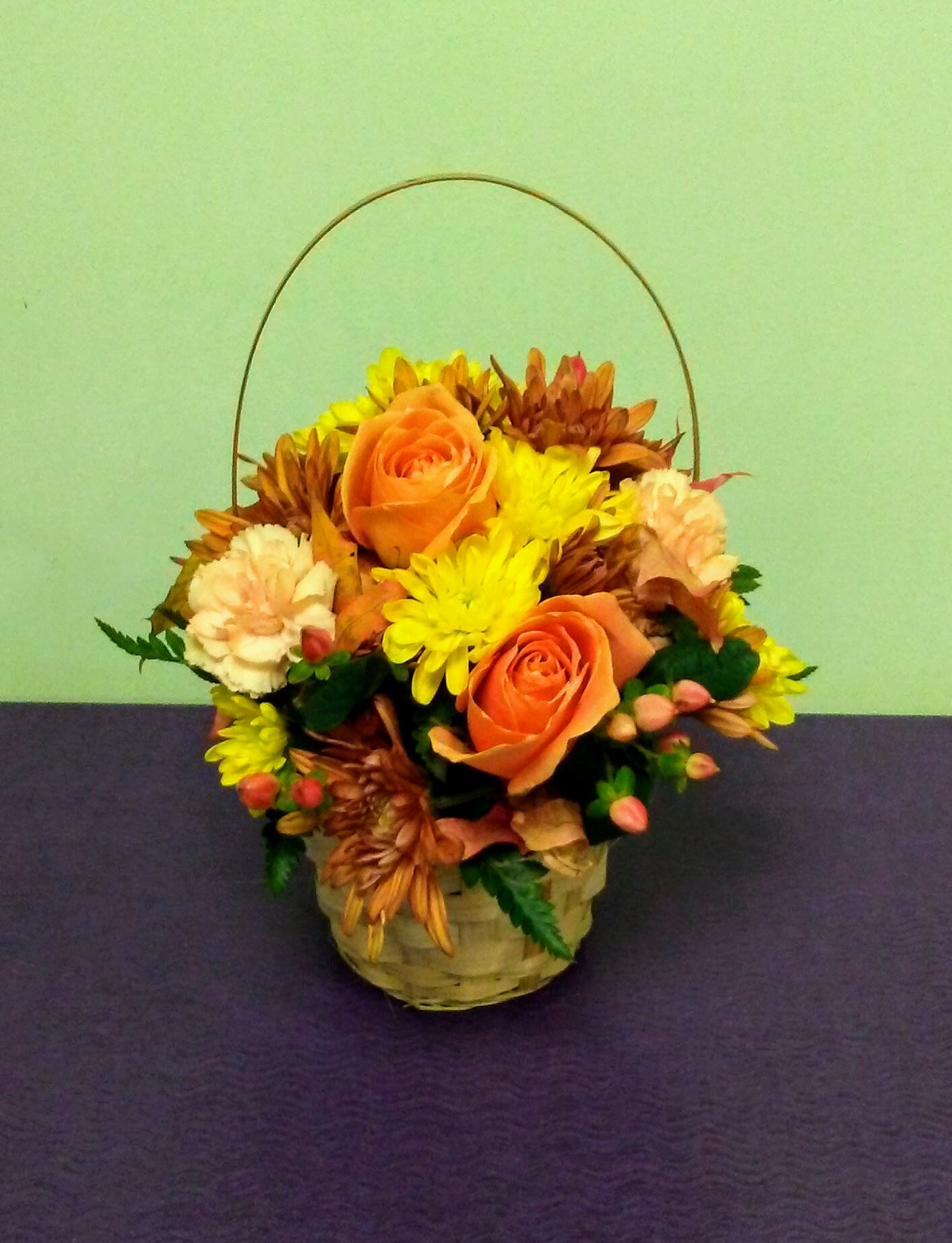 Basket arrangement with orange roses and yellow chrysanthemums