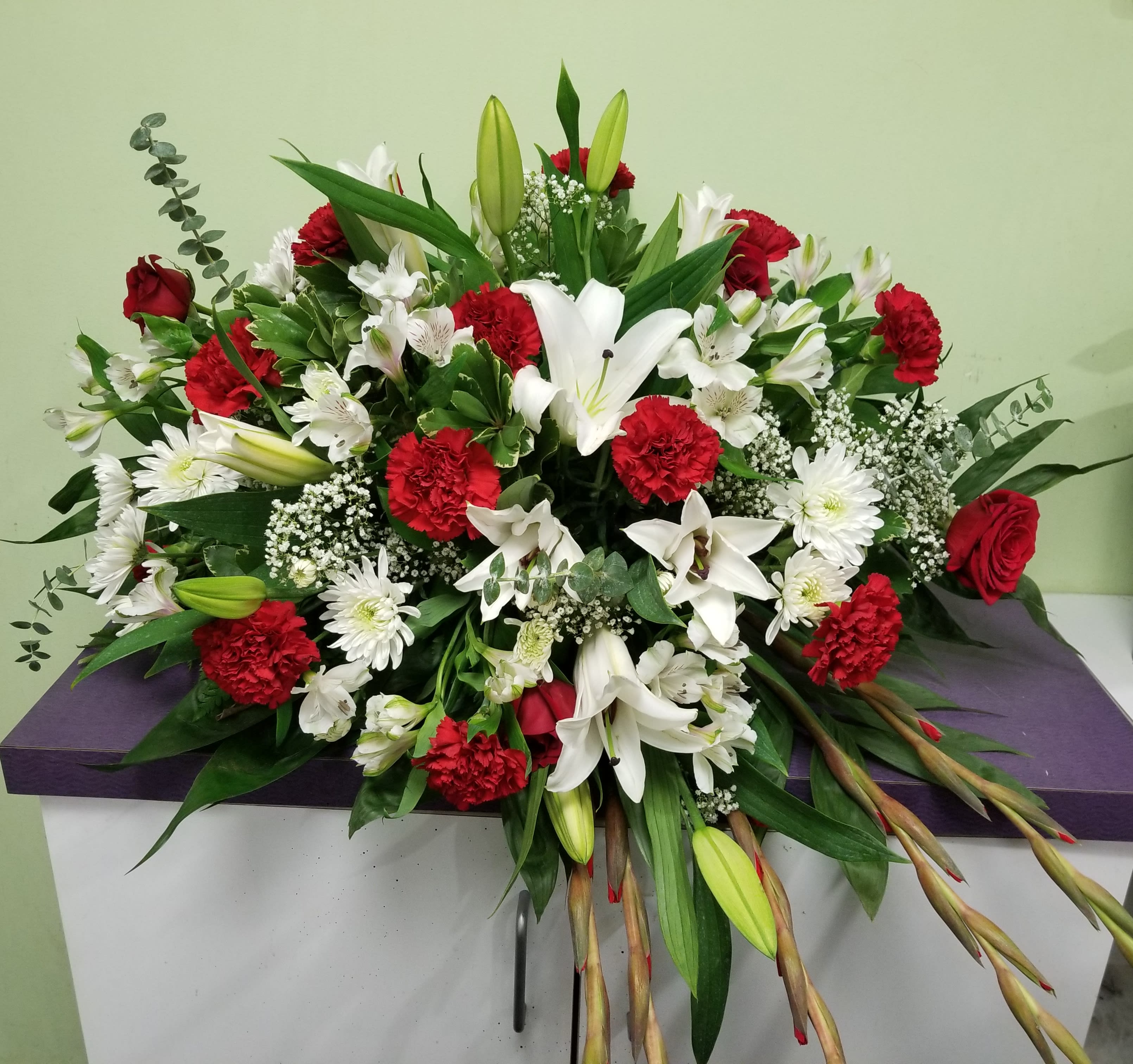 Large red and white floral spray with lilies and carnations