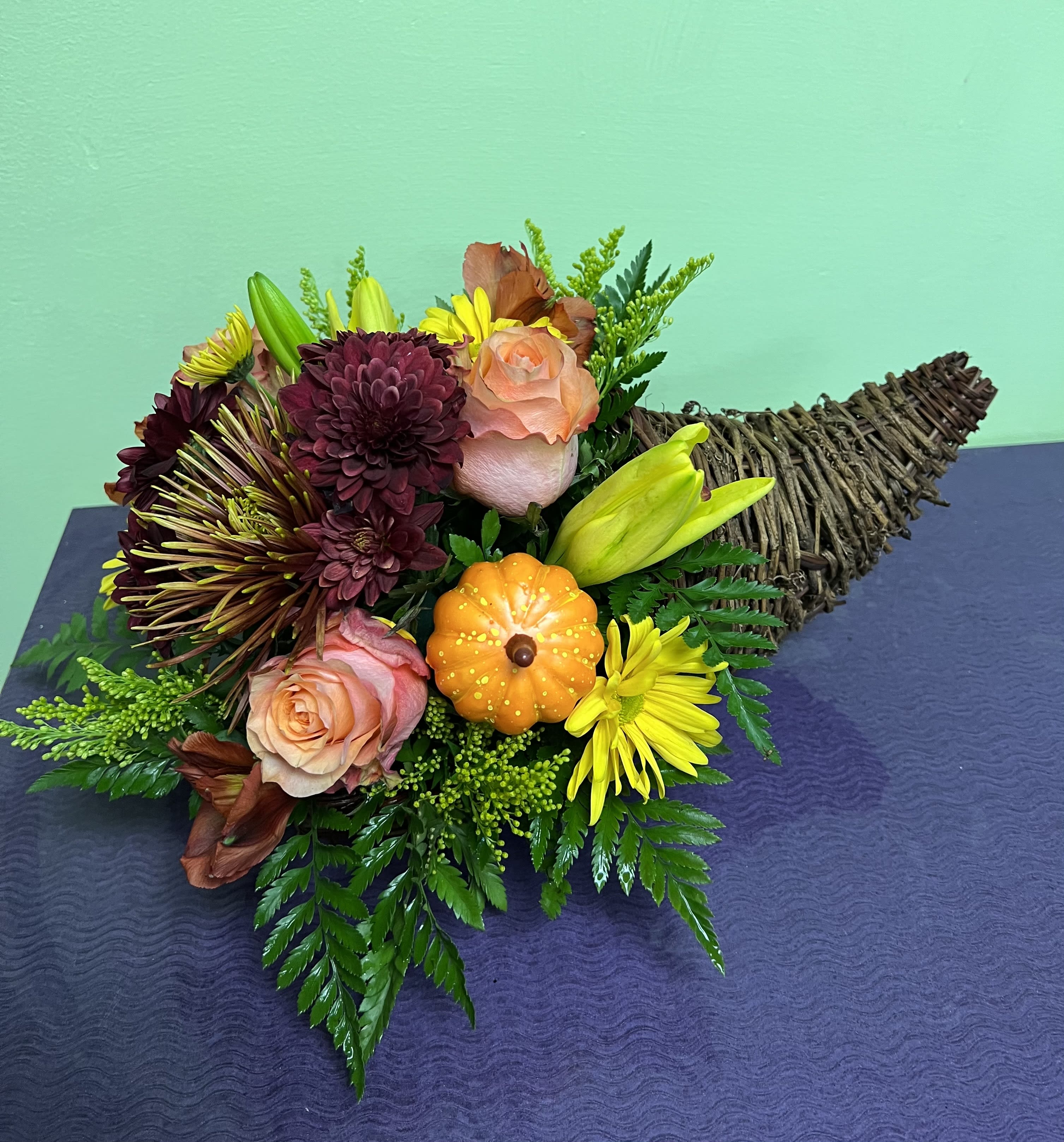 Bouquet with roses, chrysanthemums, and a small pumpkin accent