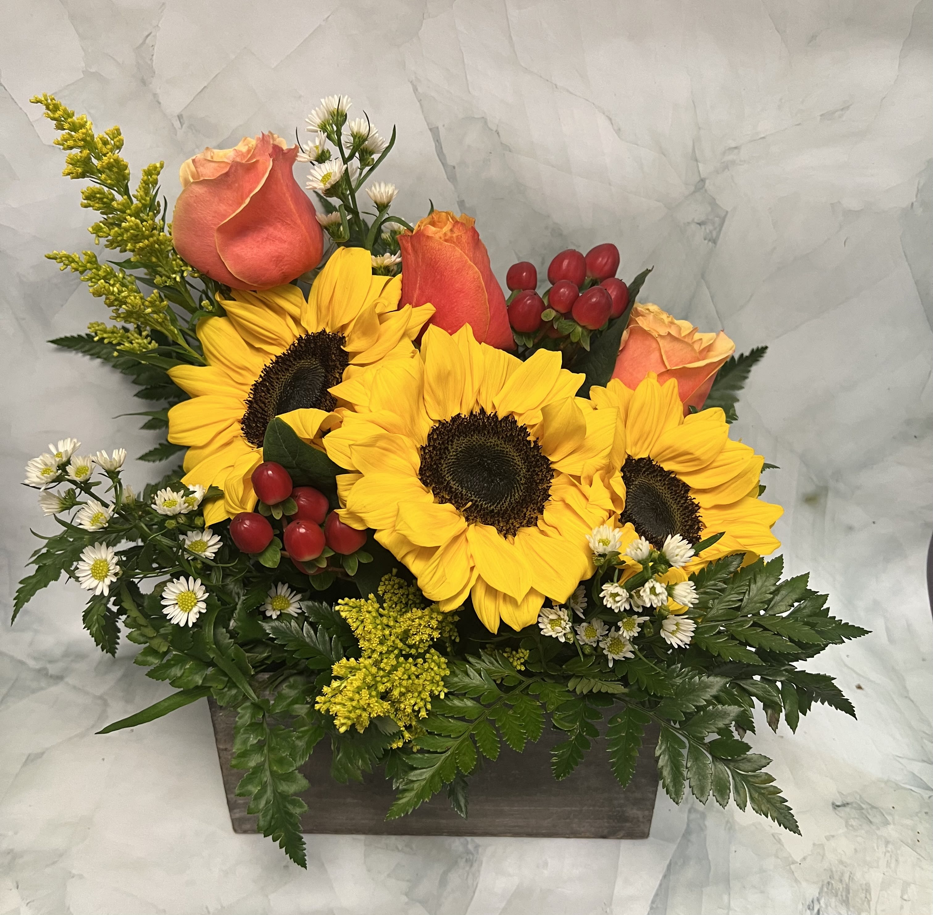 Sunflowers and peach roses in a rectangular wooden box