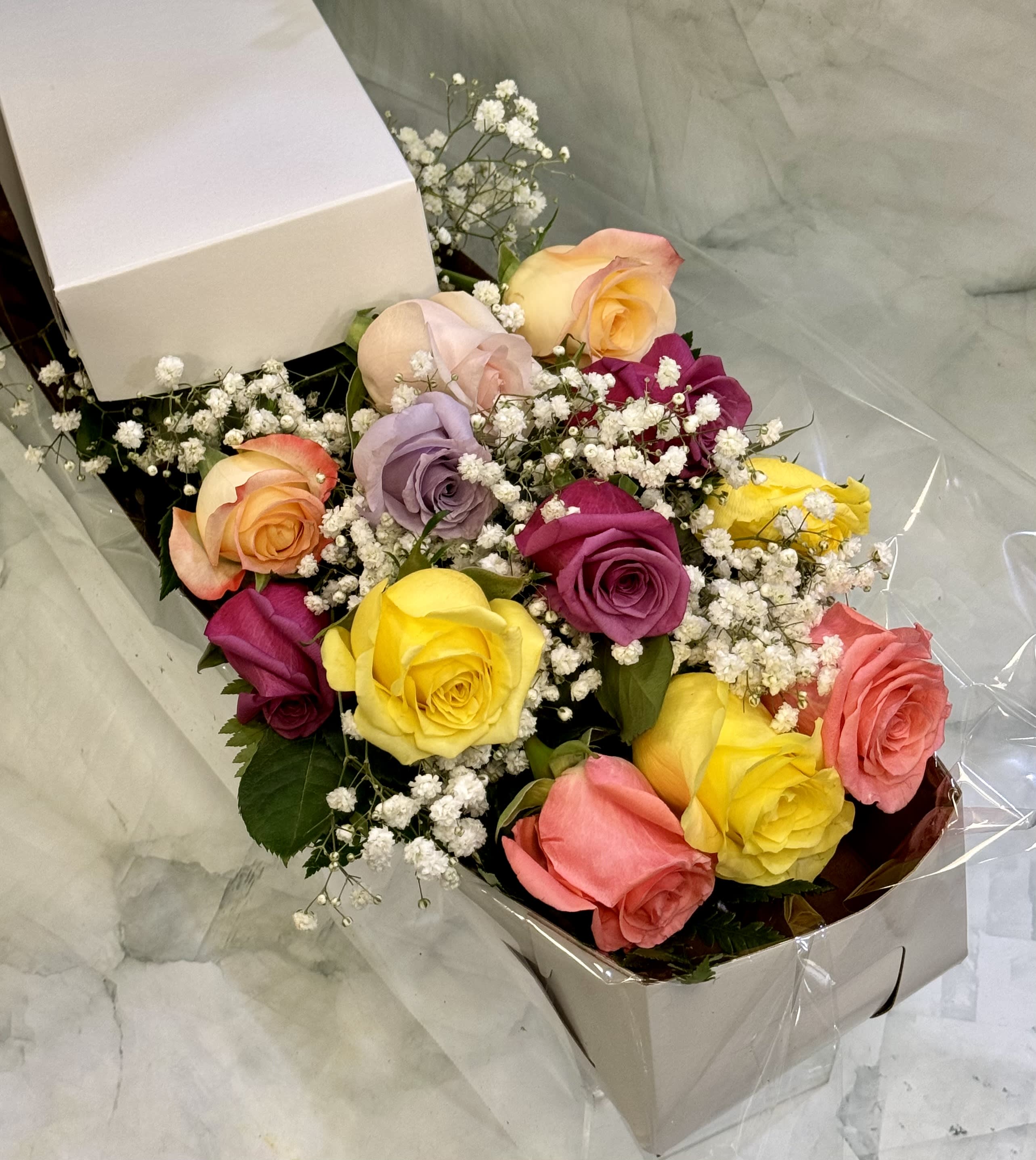 Boxed bouquet of multicolored roses with baby's breath