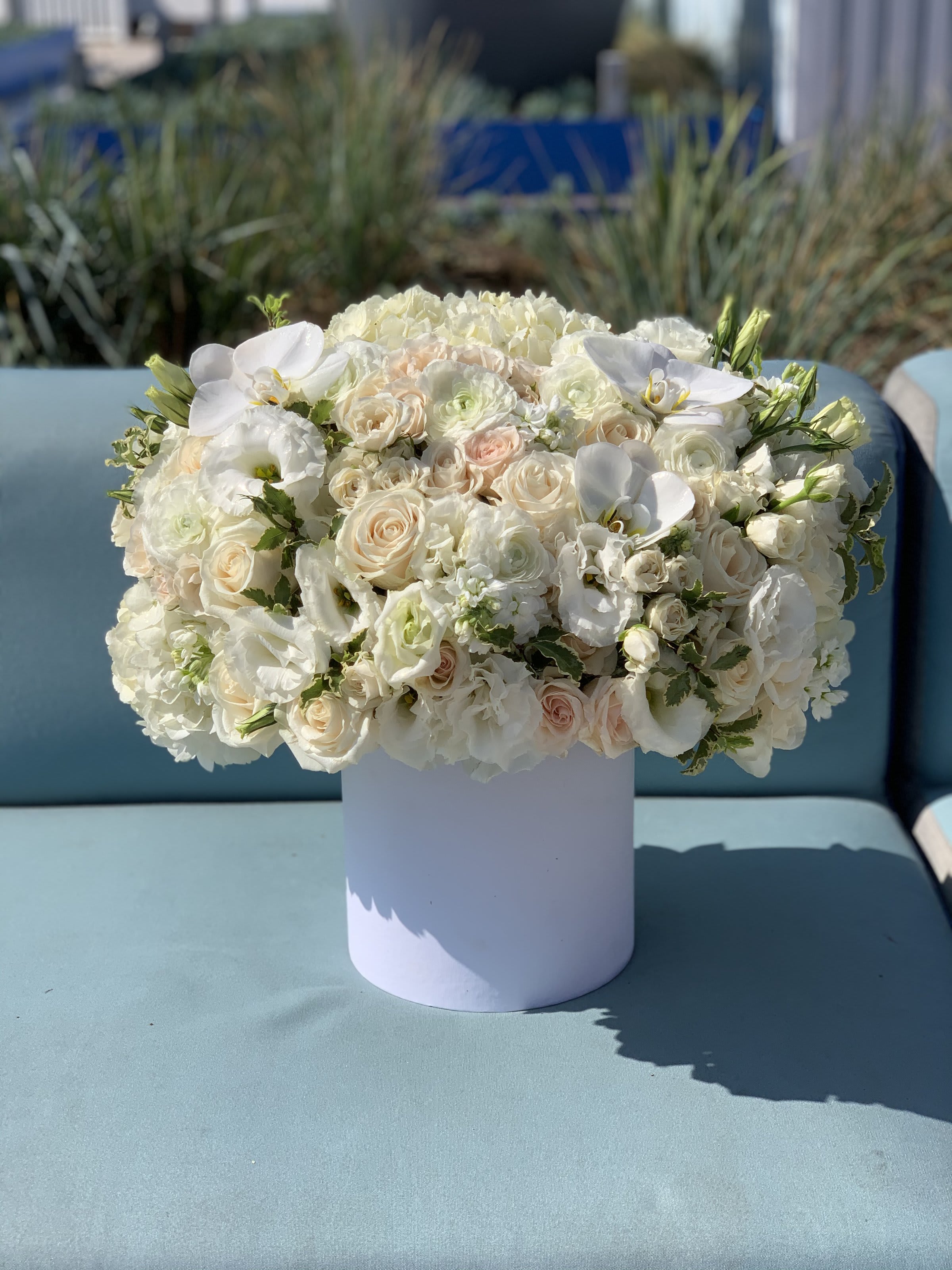 White floral arrangement in a round white vase