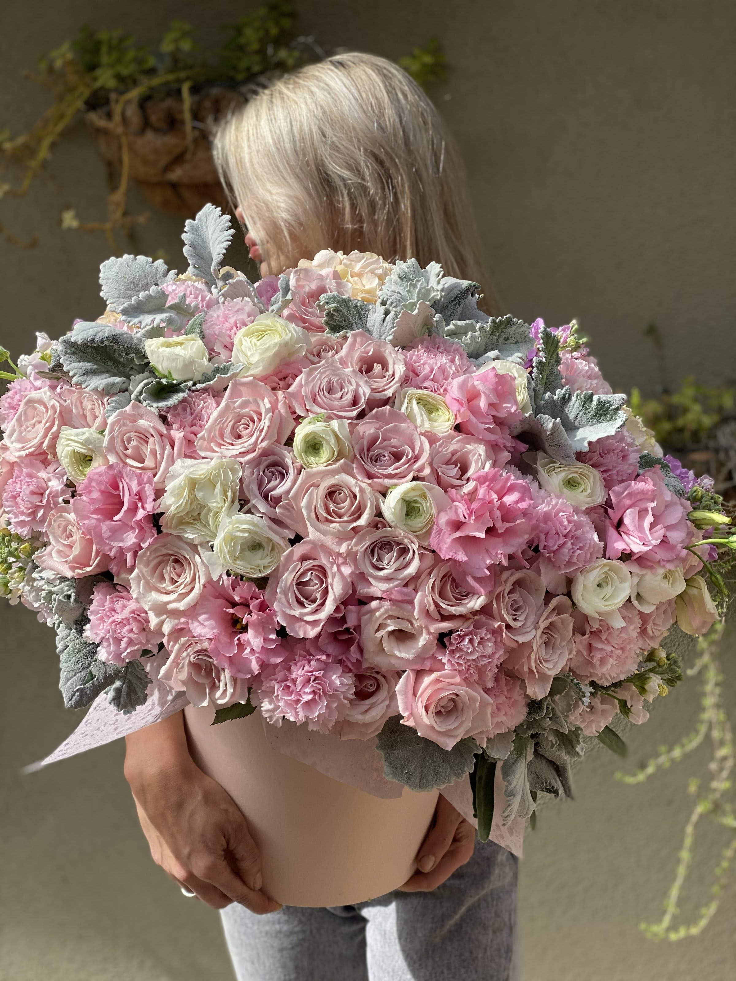 Large bouquet of pink and white roses with ruffled pink flowers