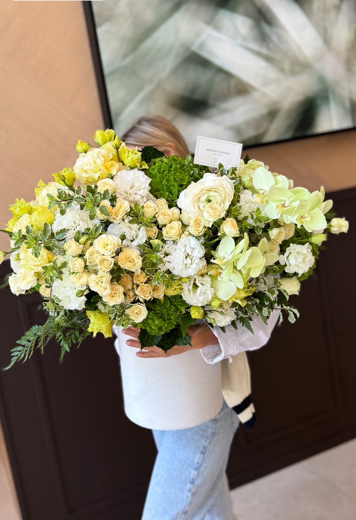 Large bouquet of white, cream, and pale green flowers