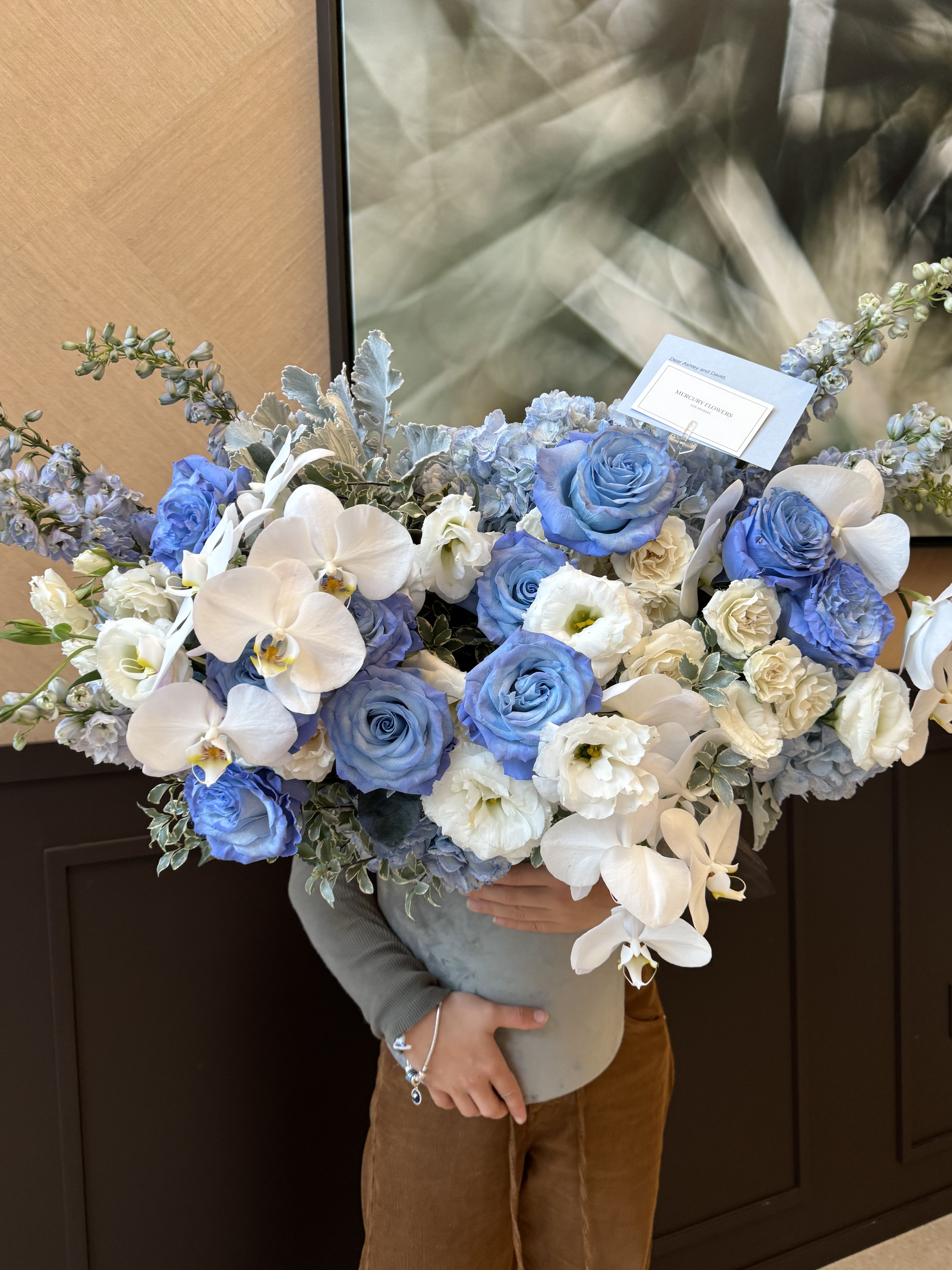 Large bouquet of blue and white roses with white orchids