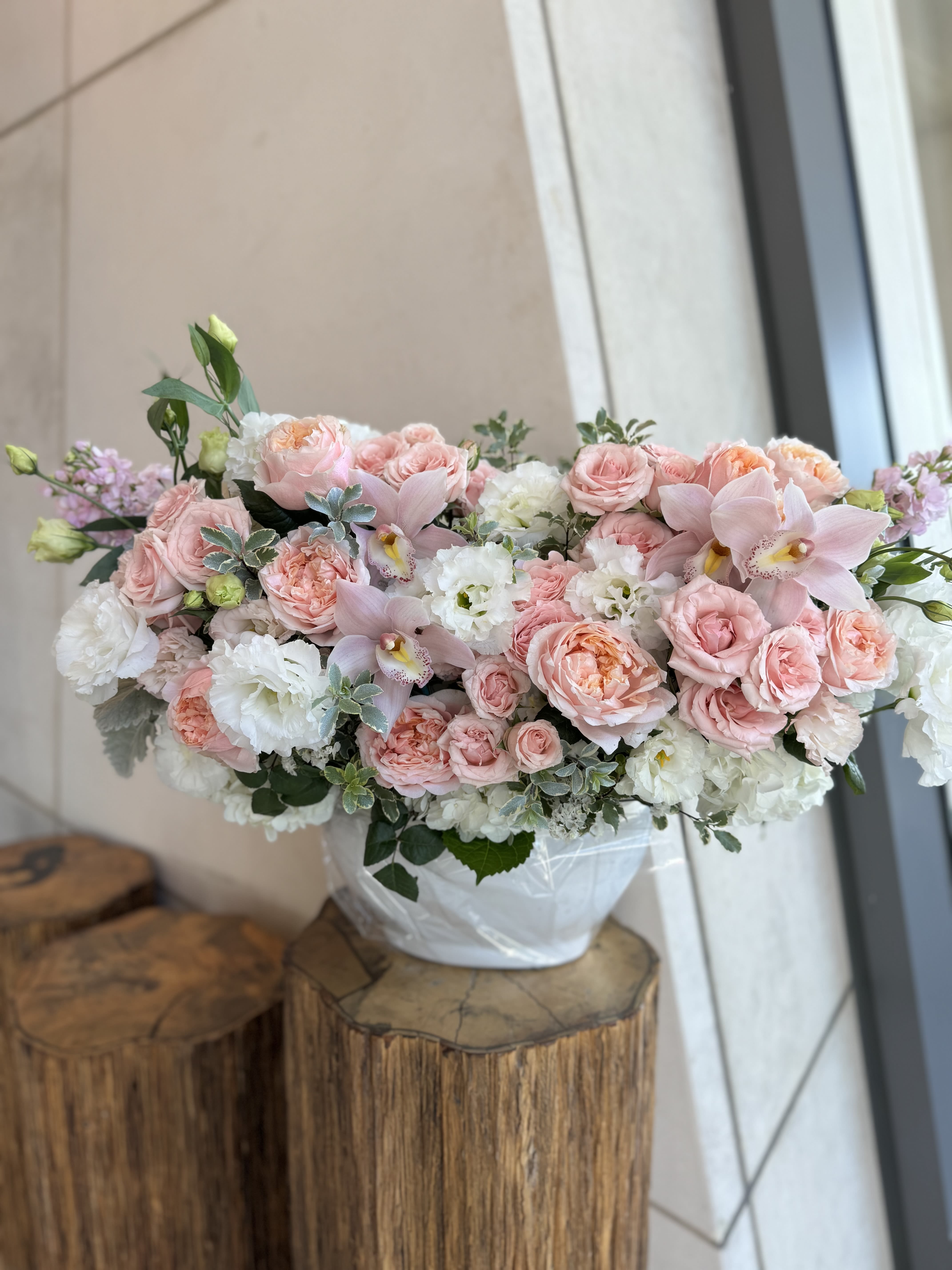 Pink and white floral arrangement in a white vase