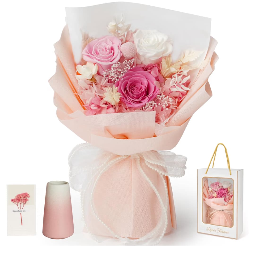 Pink and white rose bouquet wrapped in peach paper with a ribbon