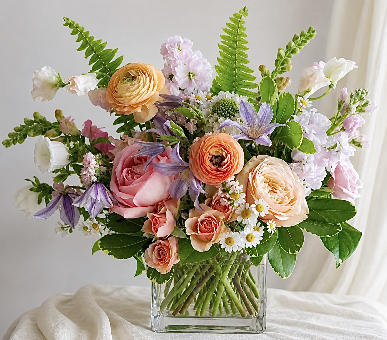 Mixed pastel bouquet in a clear glass vase