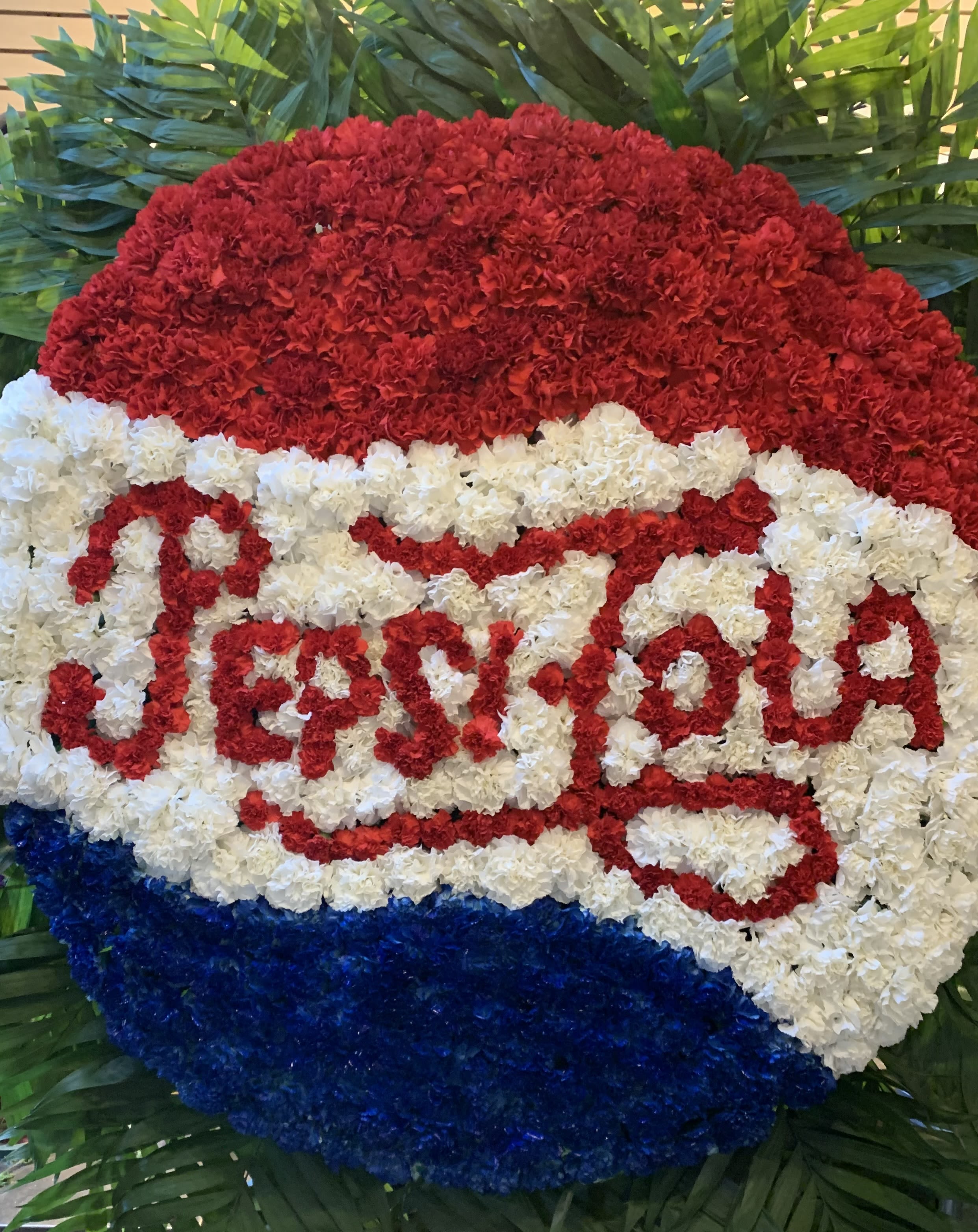 Red, white, and blue floral Pepsi logo display