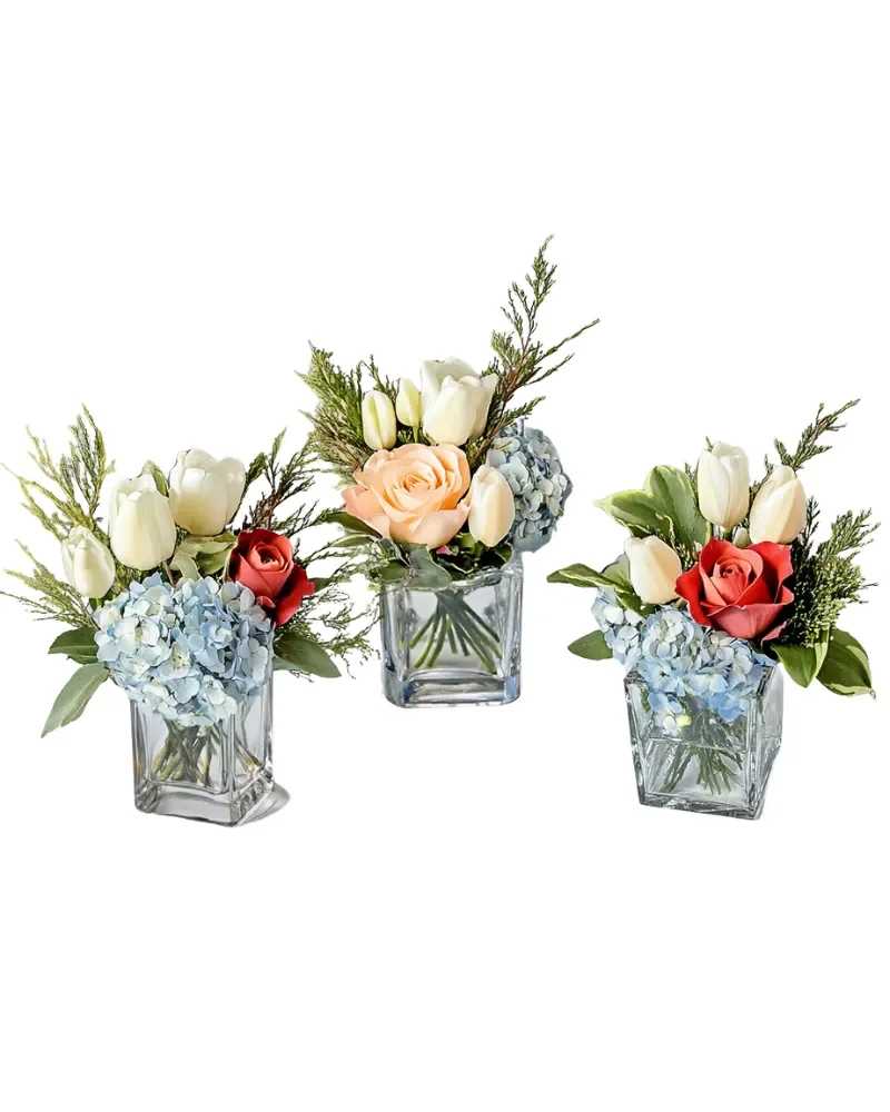 Tulip Trio - Want to tip-toe through the tulips? Our Tulip Trio will create excitement around your table. Flowers like tulips, roses, and hydrangea are tastefully arranged in three cubes to stage together or separately.