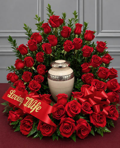 Large red rose arrangement with a memorial urn and ribbon