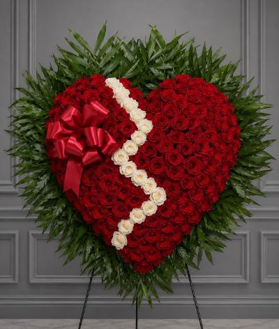 Heart-shaped standing floral tribute with red roses and white roses