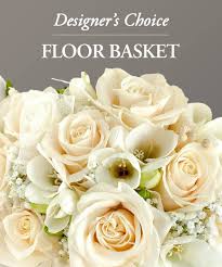 Cream roses and white calla lilies in a floor basket