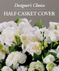 White floral half casket cover with lilies, roses, and carnations