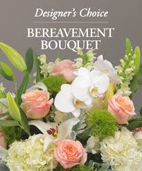 Mixed bouquet with white orchids, peach roses, and pale blooms