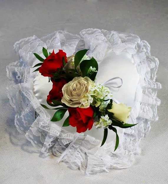 White satin ring pillow with red and cream roses