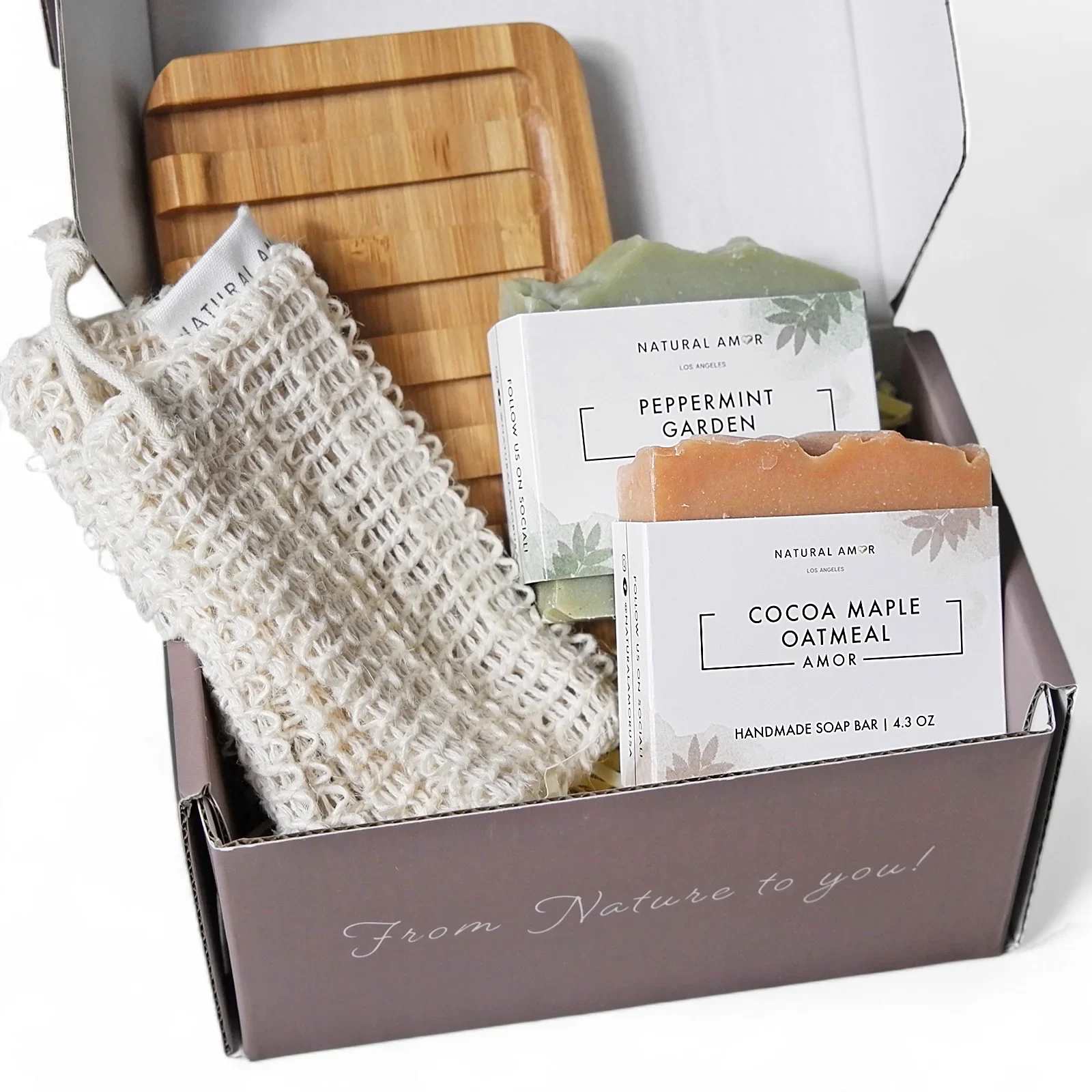 Gift box with handmade soap bars, a wooden tray, and a soap saver pouch