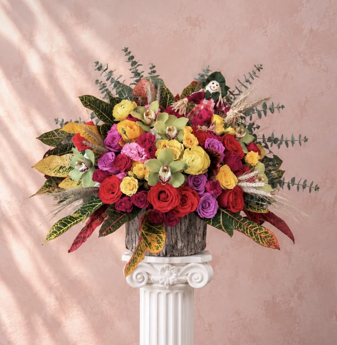 Colorful bouquet of roses and orchids in a rustic container
