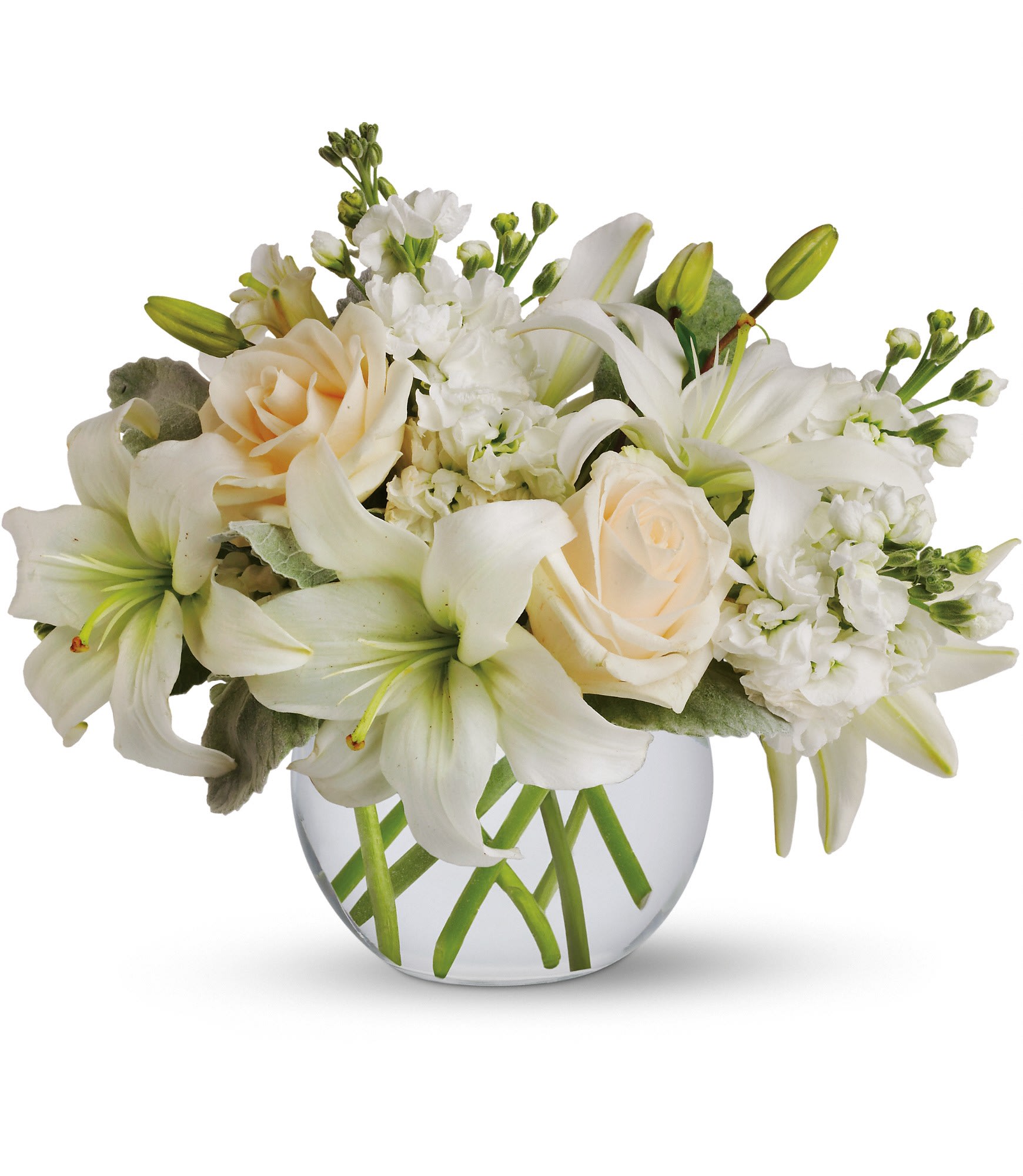 White lilies and cream roses arranged in a clear glass vase