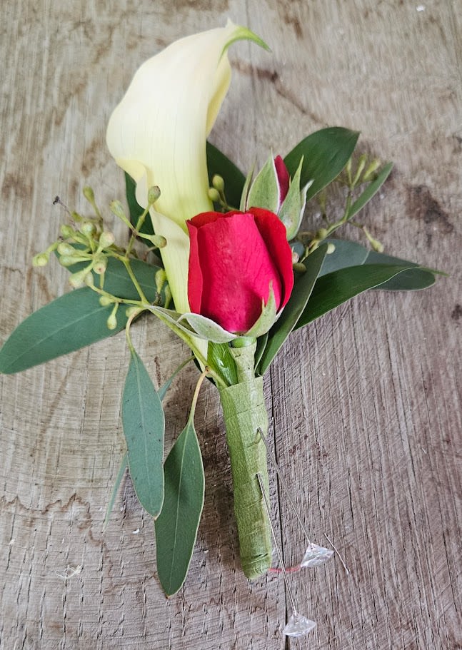 Boutonniere with a white calla lily and red rose bud