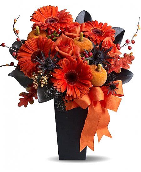 Halloween Glow - Light up the spooky season with Halloween Glow, a dazzling orange and black floral arrangement that captures the fun and flair of fall! This striking bouquet features vibrant orange gerbera daisies, lush roses, festive mini pumpkins, and dark accents — all hand-arranged in a sleek black vase and finished with a bold orange ribbon. Designed to bring seasonal spirit to your home, office, or Halloween party, Halloween Glow is a show-stopping centerpiece that blends elegance with a touch of spooky charm. Each arrangement is handcrafted by your local florist in Omaha Metro area and available for same-day flower delivery if ordered by 12 Noon central time. Perfect for: Halloween parties &amp; fall decorating Festive gifts for friends and coworkers Autumn birthdays &amp; special events Adding seasonal warmth to any room