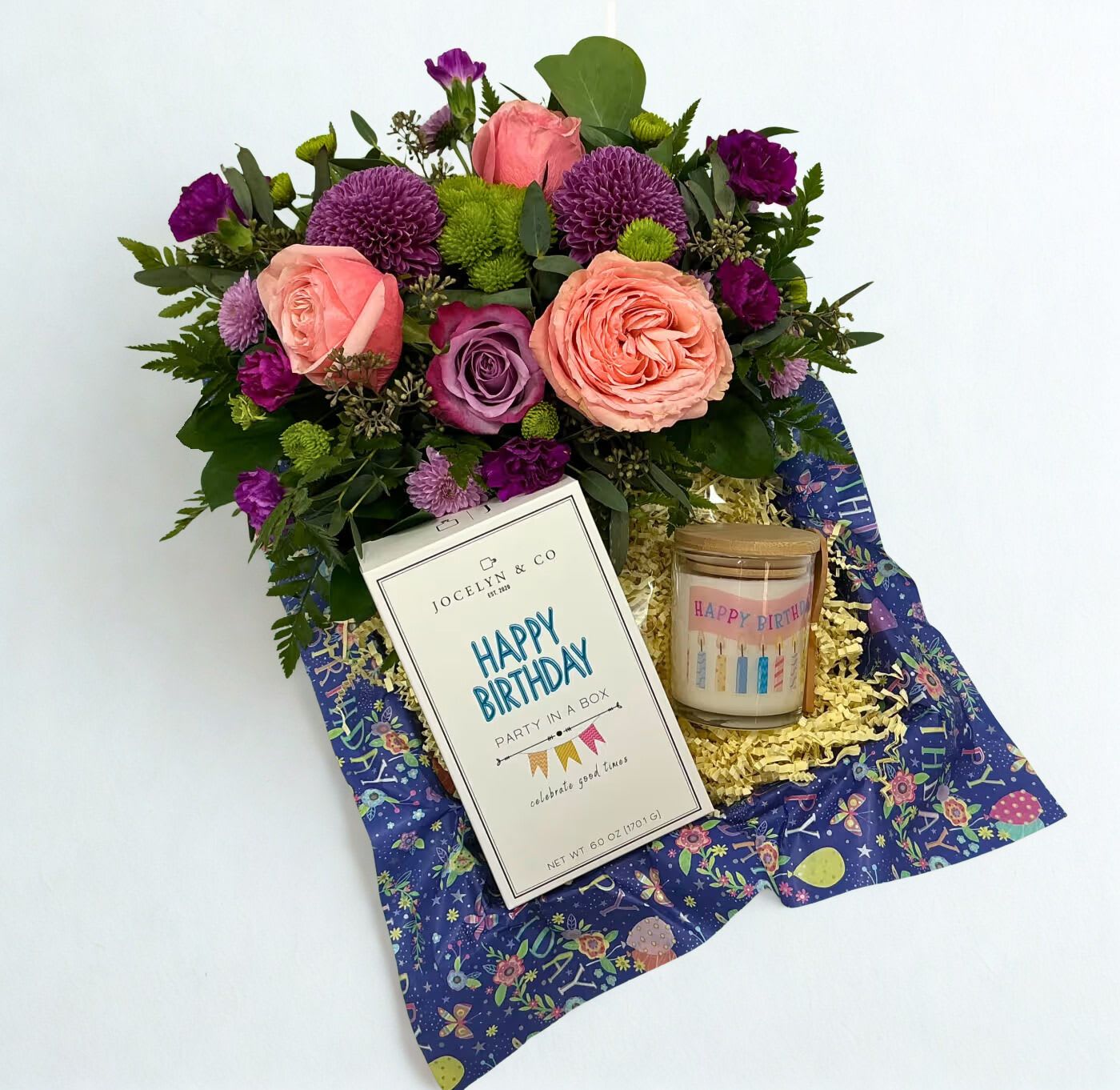 Mixed pink and purple flower bouquet with a birthday candle and card