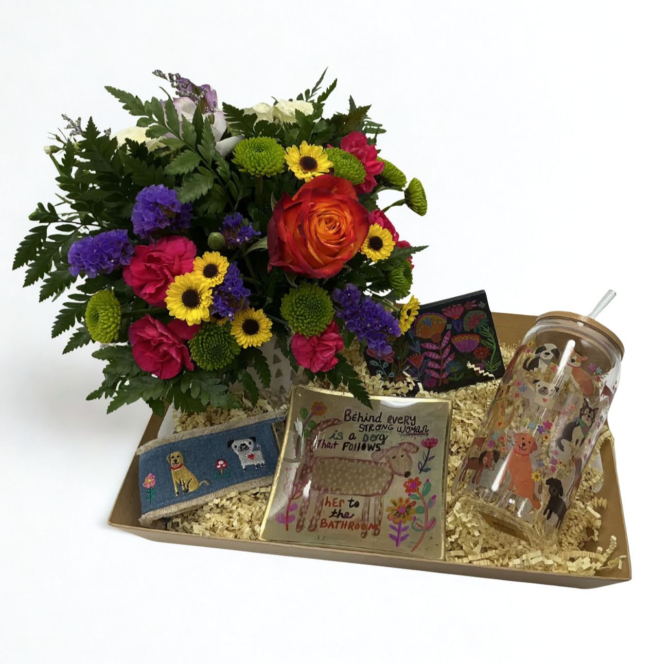 Bark &amp; Bloom Box - Celebrate the love of a dog mom this Mother’s Day with the Bark &amp; Bloom Gift Box   This curated set features a fresh floral arrangement in a keepsake mug, a dog-themed tumbler for on-the-go sips, a cute dog keychain, and a glass trinket dish that reads: “behind every strong woman is a dog that follows her to the bathroom.” To top it off, we’ve included a cute purse sized pack of lint/fur remover sheets—because dog hair is part of the love.  Thoughtful, practical, and full of personality, it’s the perfect gift for moms who adore their pups. 