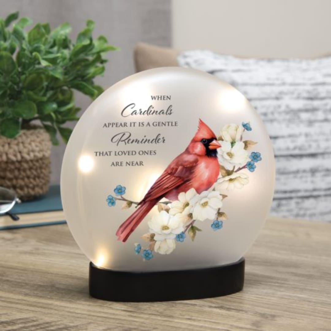 Cardinal memorial light on a black base with floral artwork and text