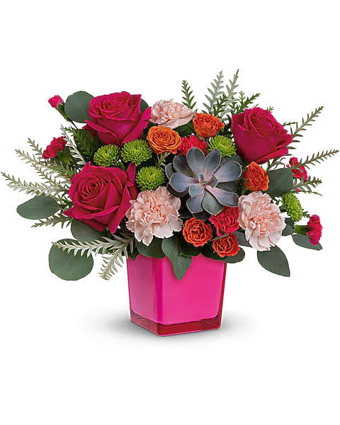 Pink roses and carnations in a bright pink vase with a succulent accent
