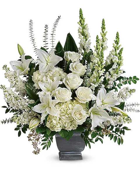White lilies and roses arranged in a dark vase