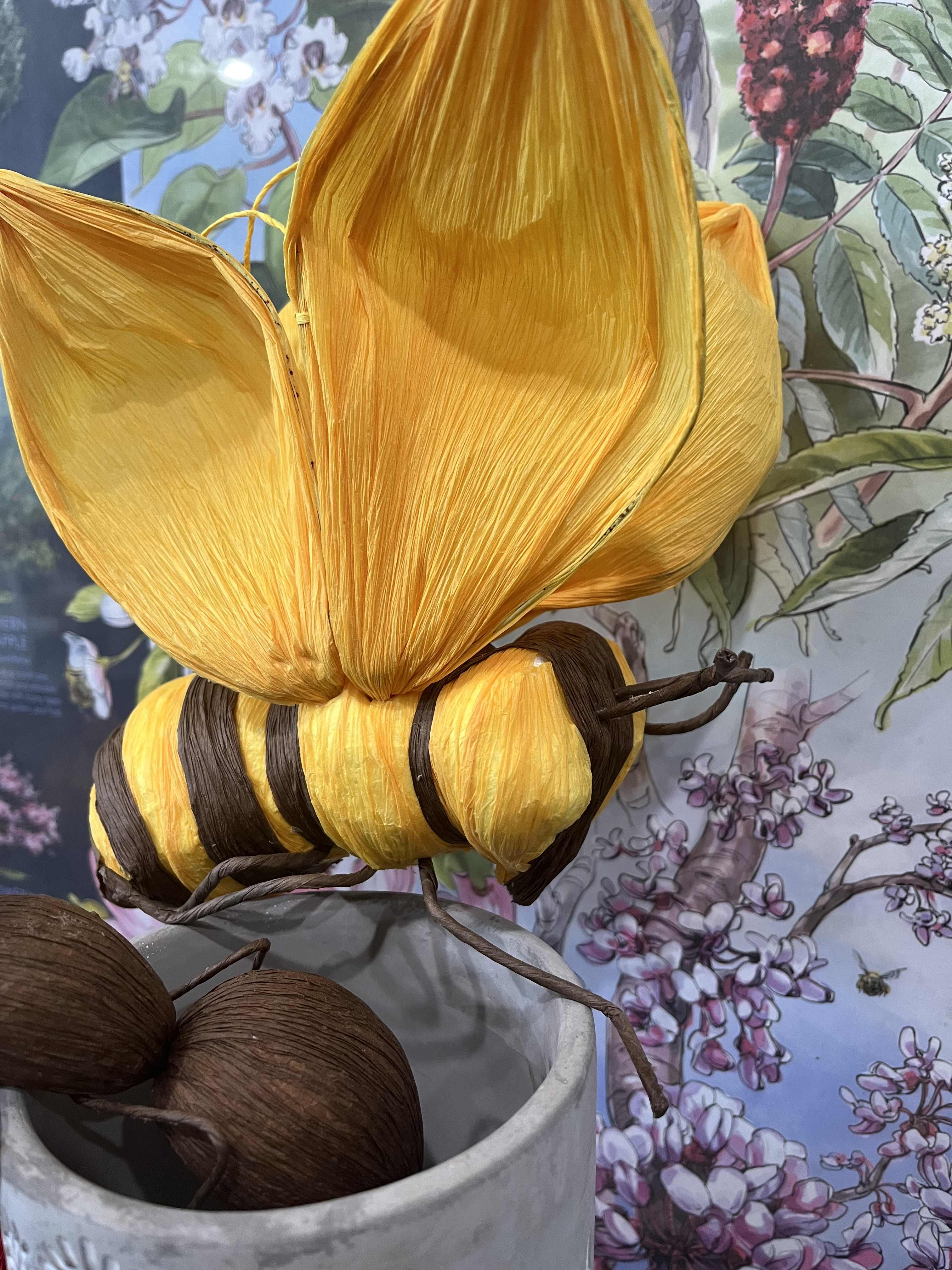 Decorative yellow and brown butterfly sculpture in a vase