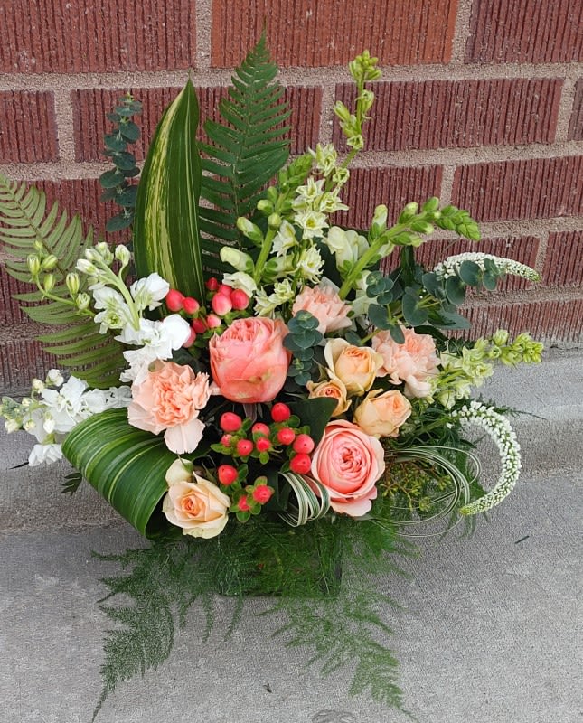 Mixed bouquet with peach roses, white blooms, and greenery