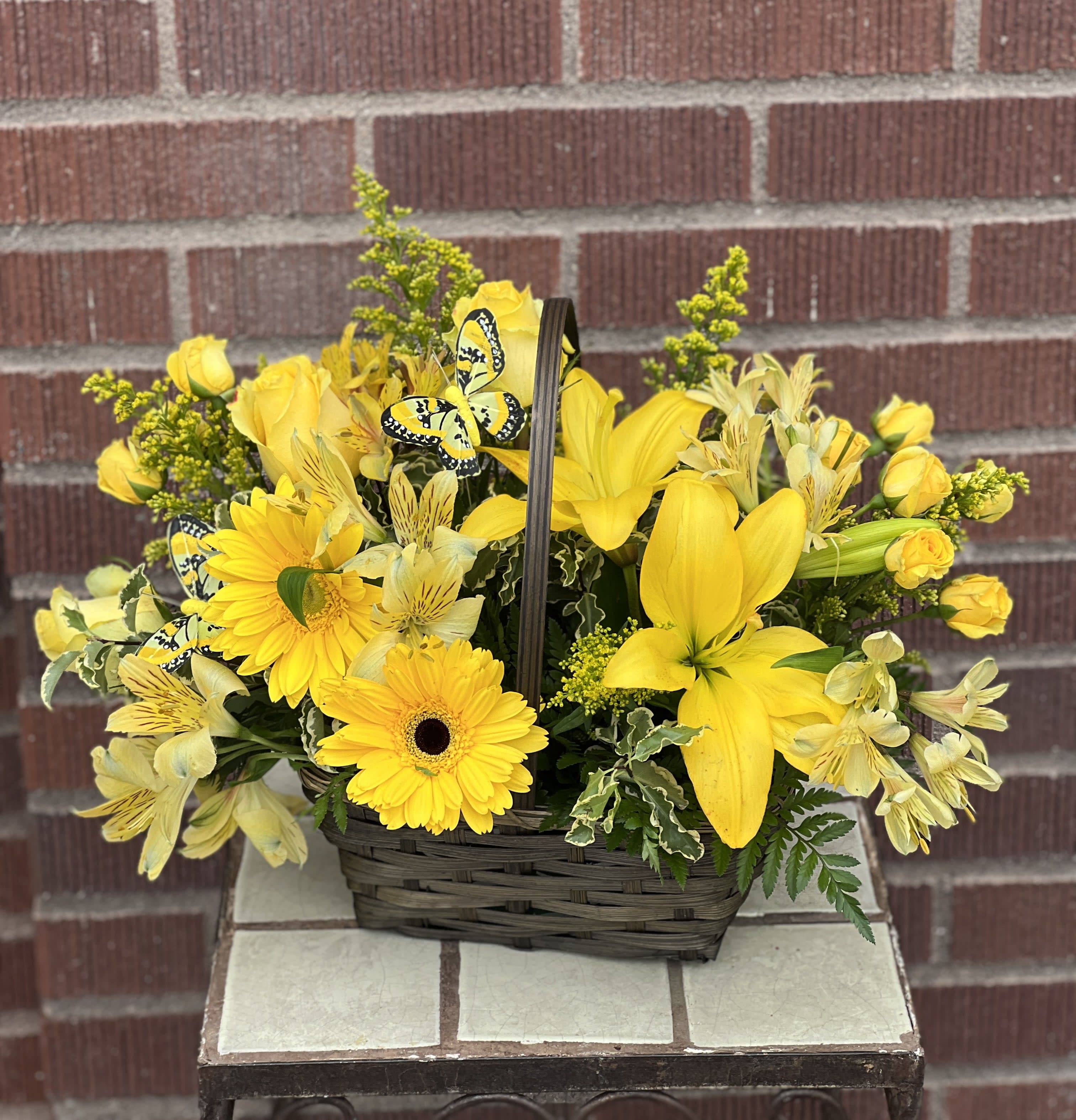 Yellow floral basket with roses, lilies, and daisies