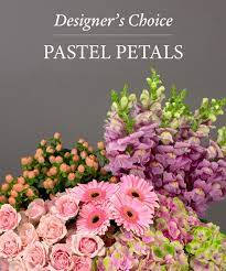 Pastel flower arrangement with pink daisies, roses, and purple blooms