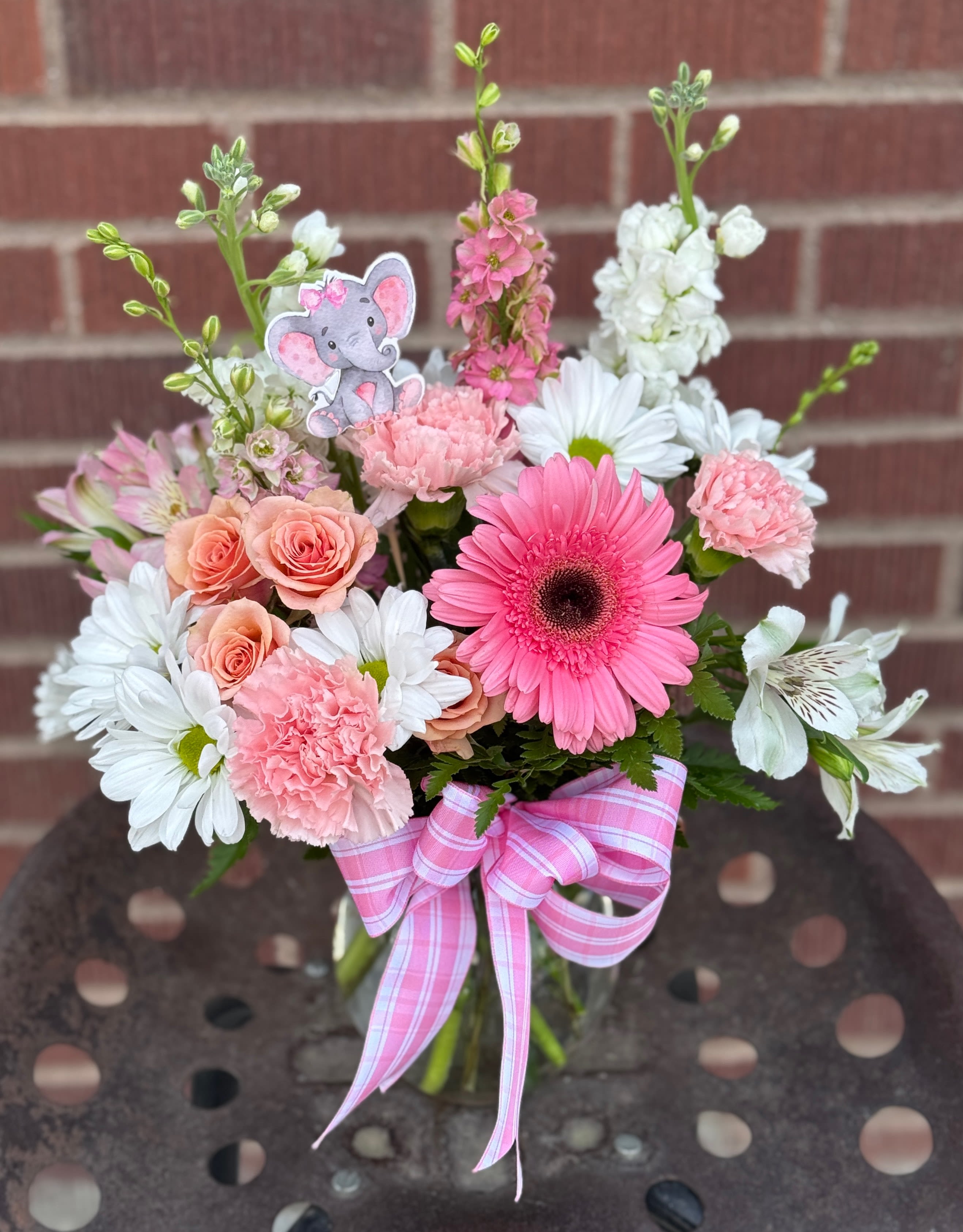 Pink and white mixed bouquet with a pink ribbon and elephant pick