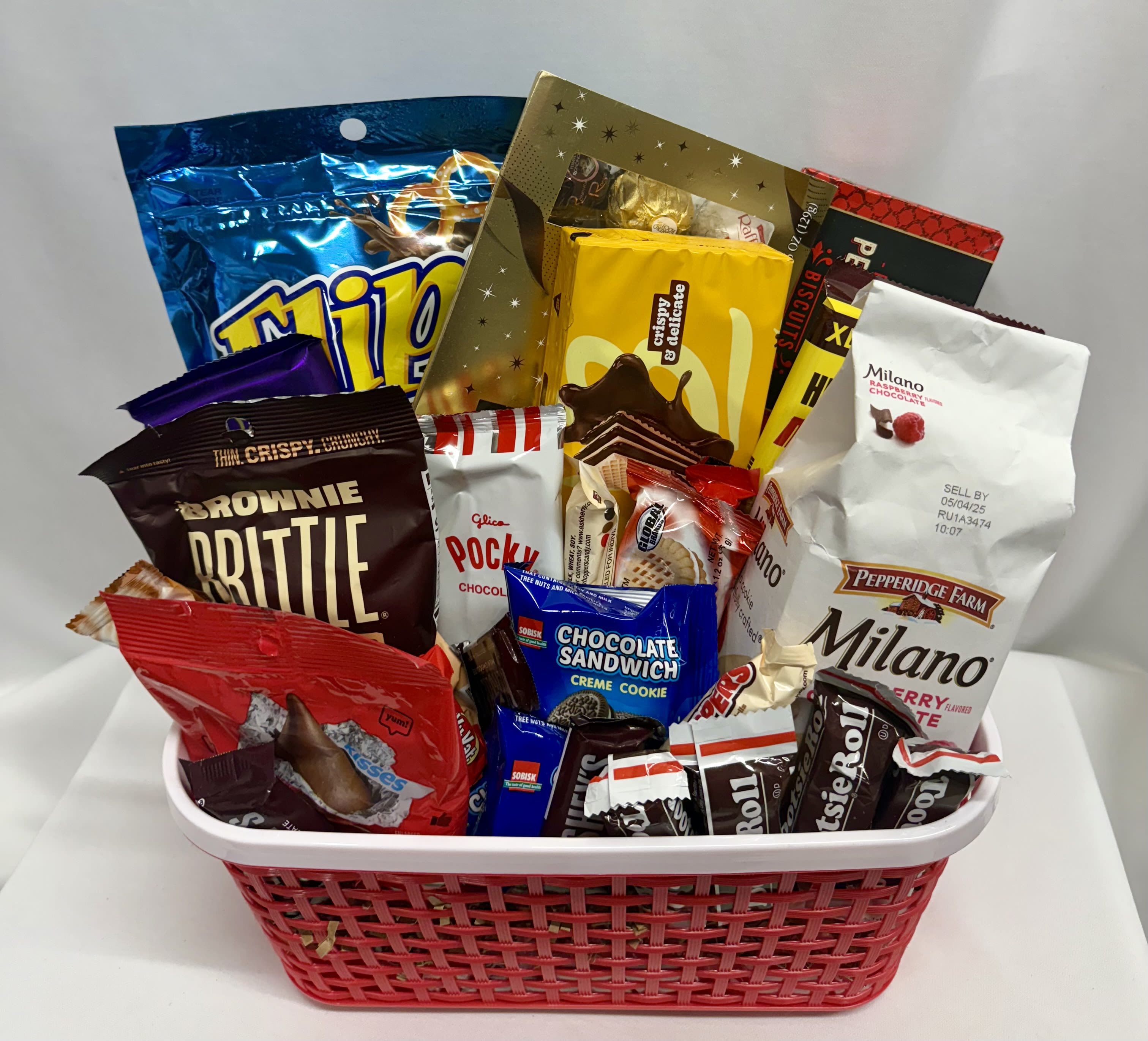 Basket filled with assorted packaged chocolates and cookies