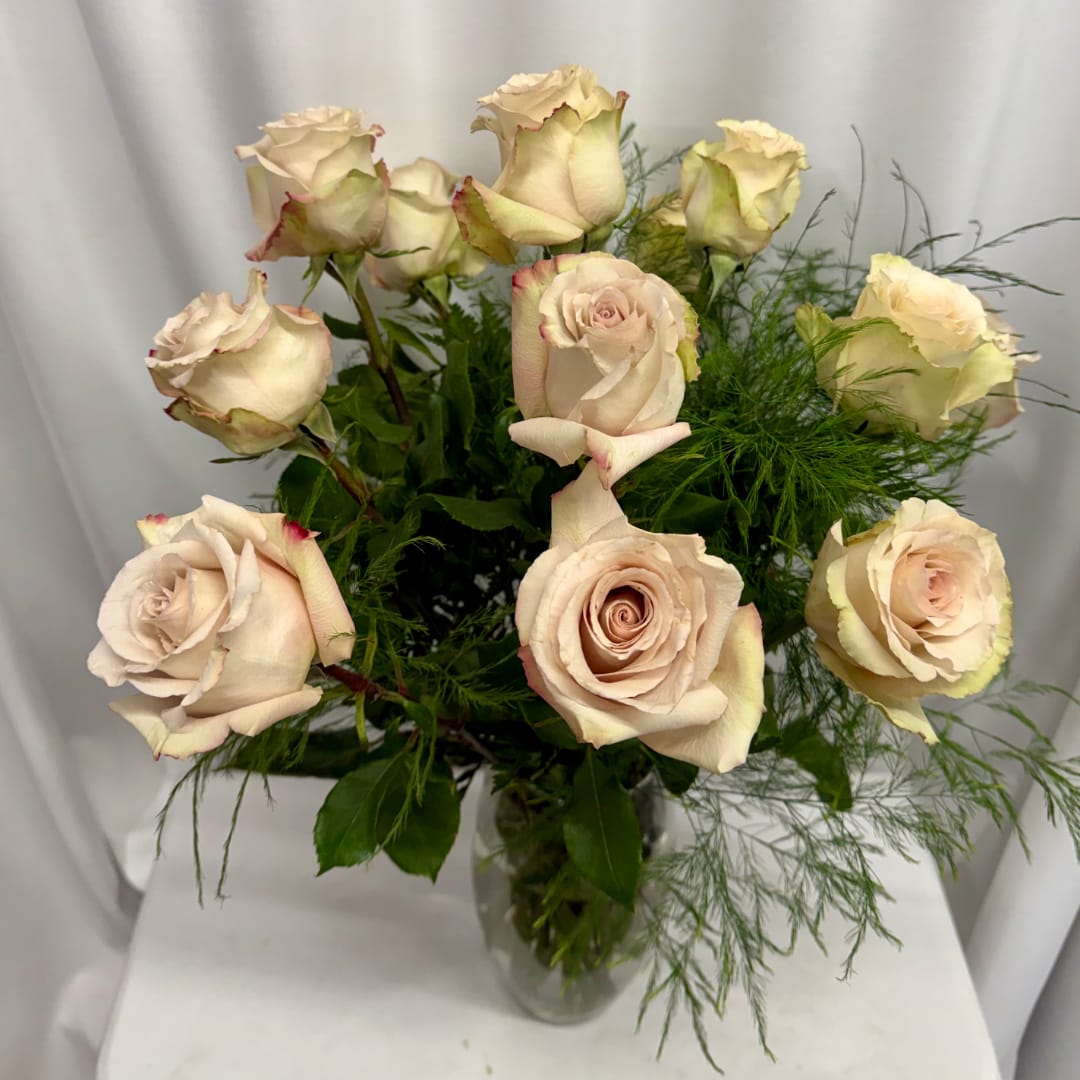 Bouquet of pale blush roses in a clear glass vase