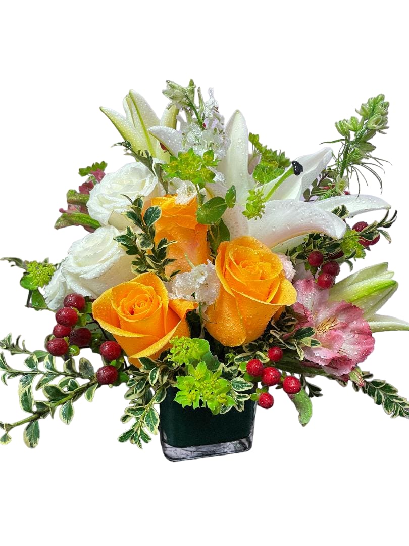 Orange roses and white lilies in a black vase with red berries