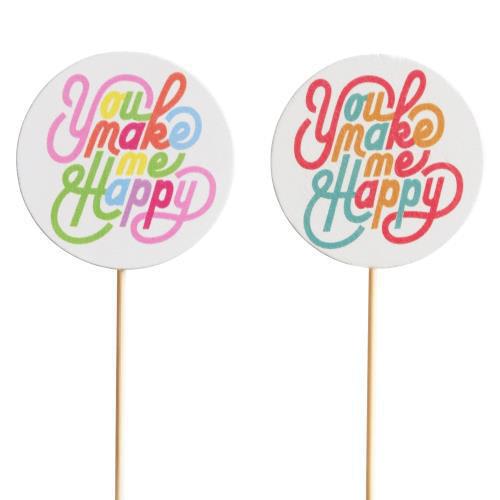 Two round cake toppers with colorful "You make me happy" text