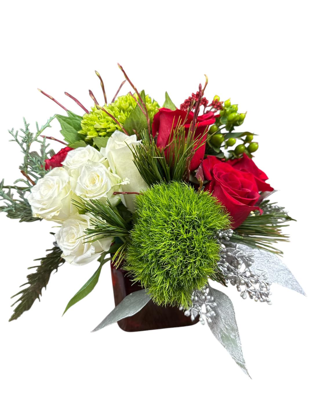Red and white roses with green accents in a square vase