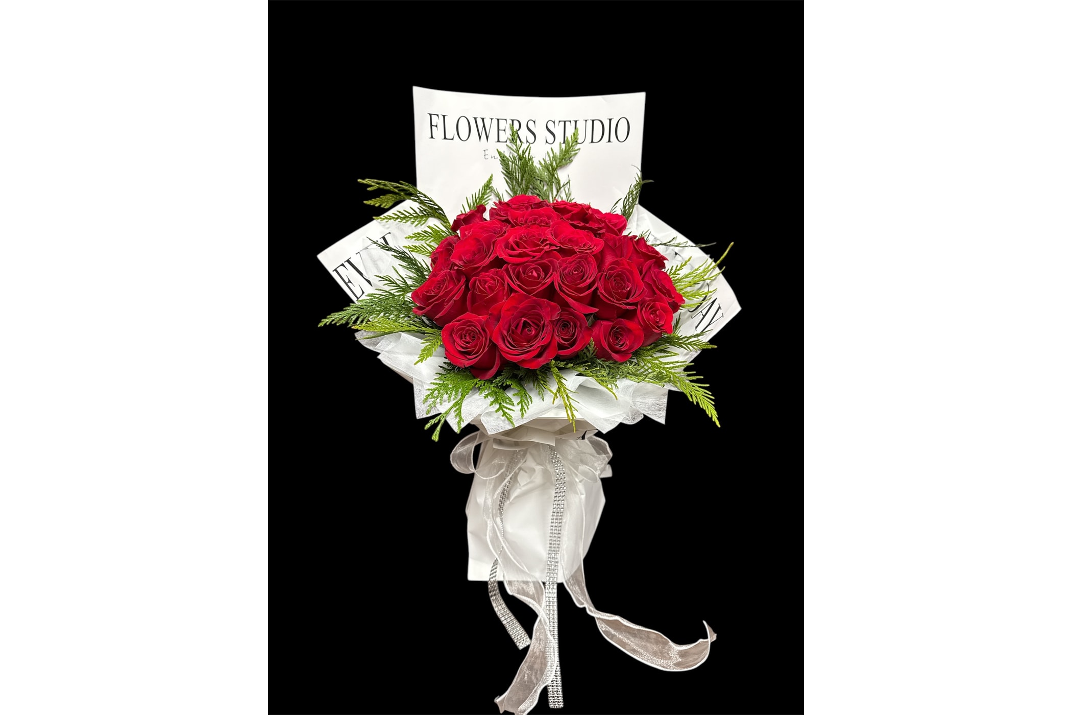 Bouquet of red roses with white wrapping and ribbon