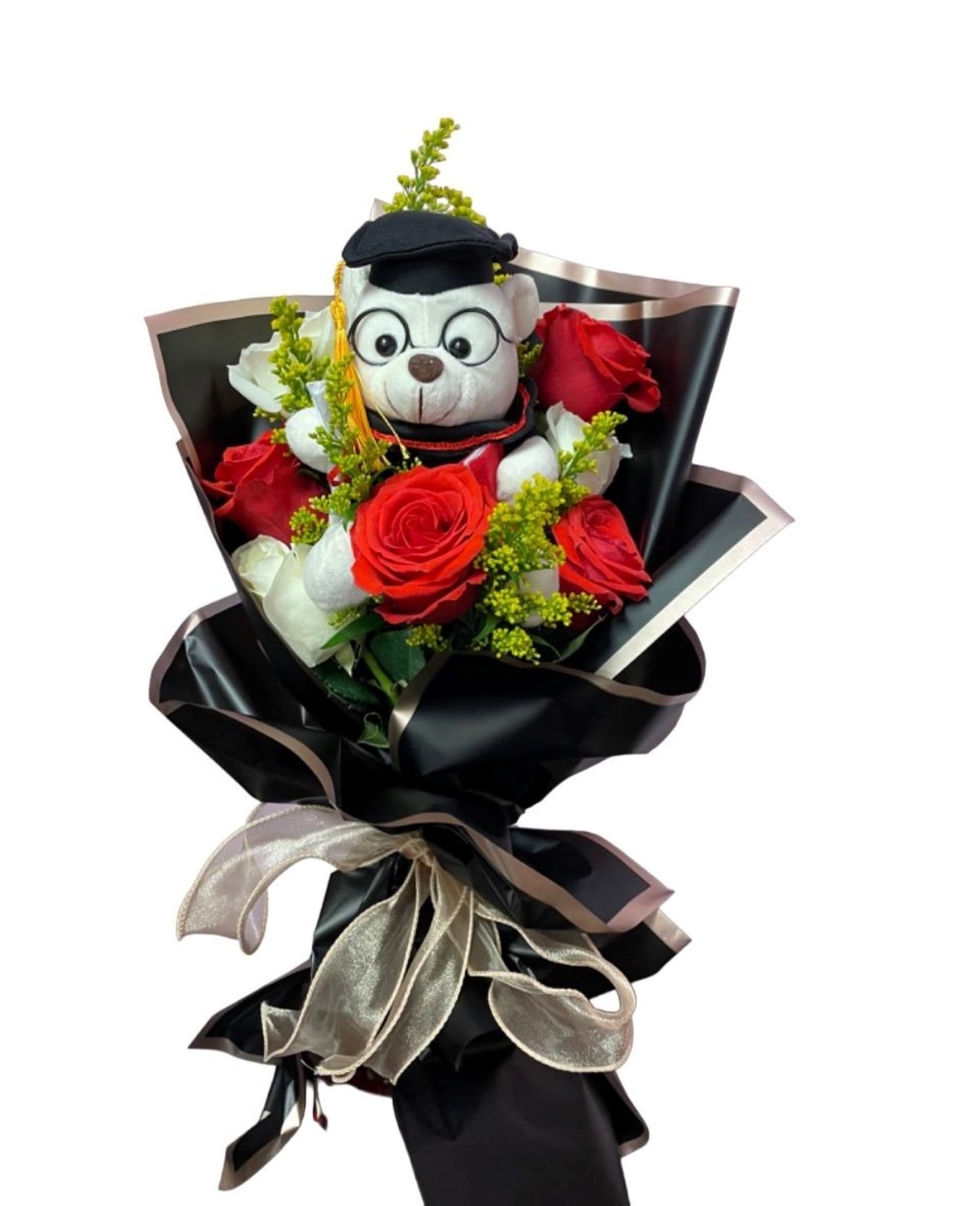 Bouquet of red roses with a teddy bear in graduation cap
