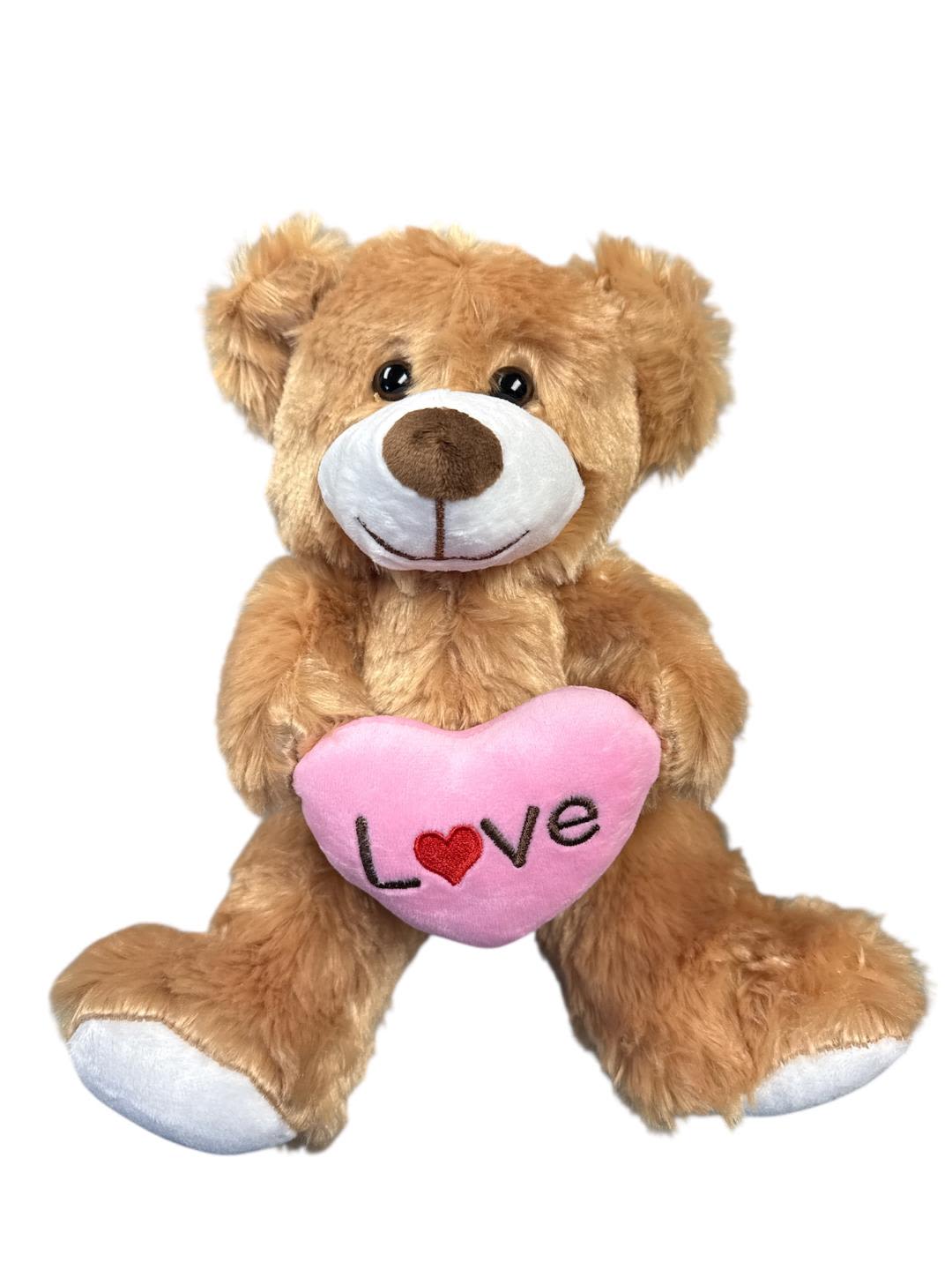 Brown teddy bear holding a pink heart with the word Love