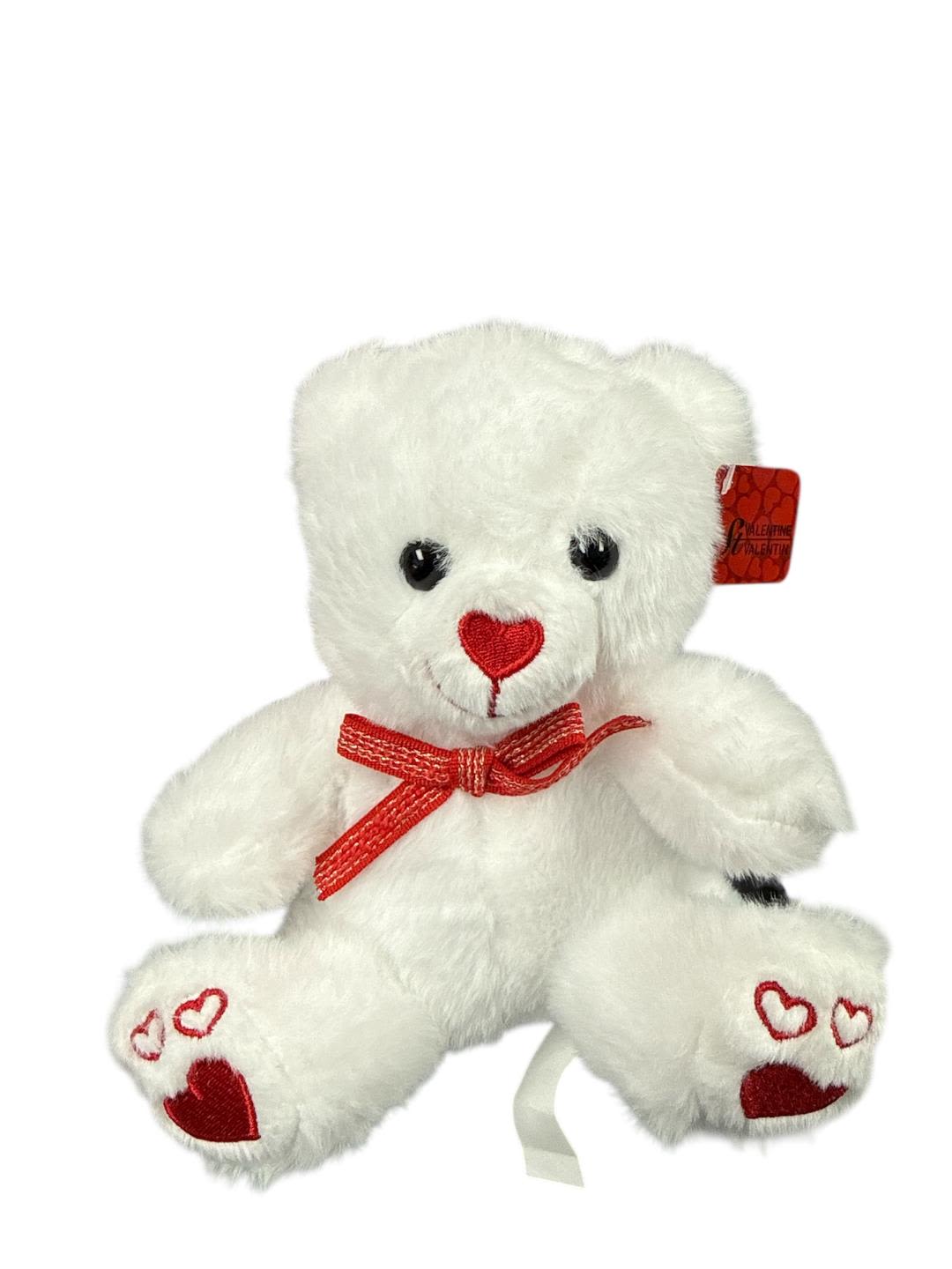 White teddy bear with red heart details and a red bow