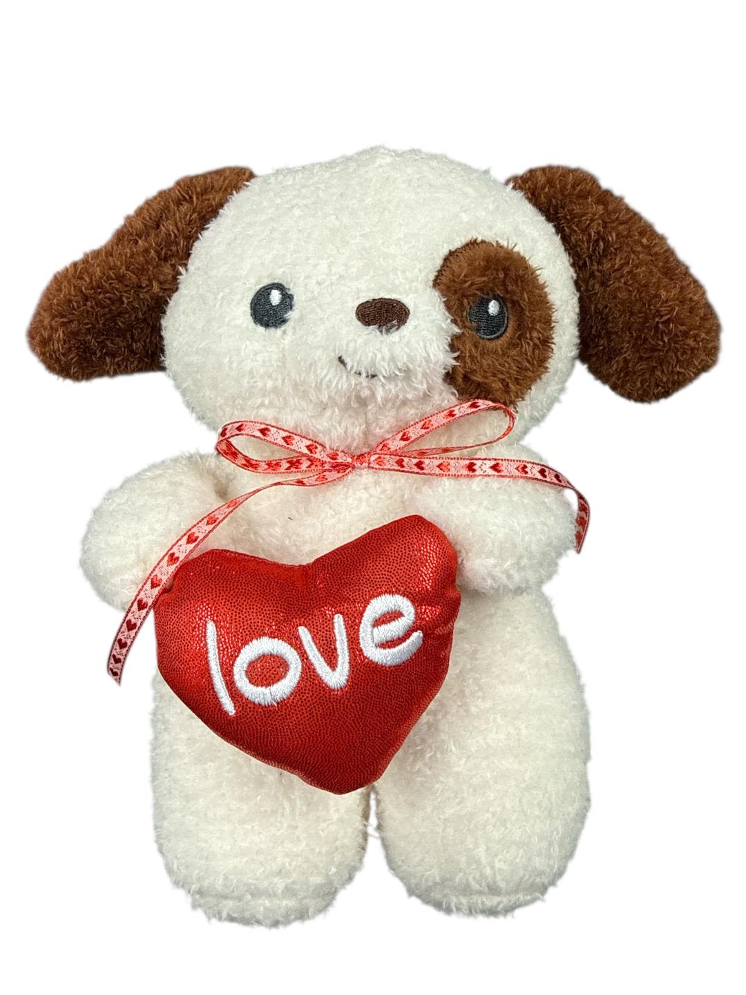 Plush puppy holding a red heart with the word love