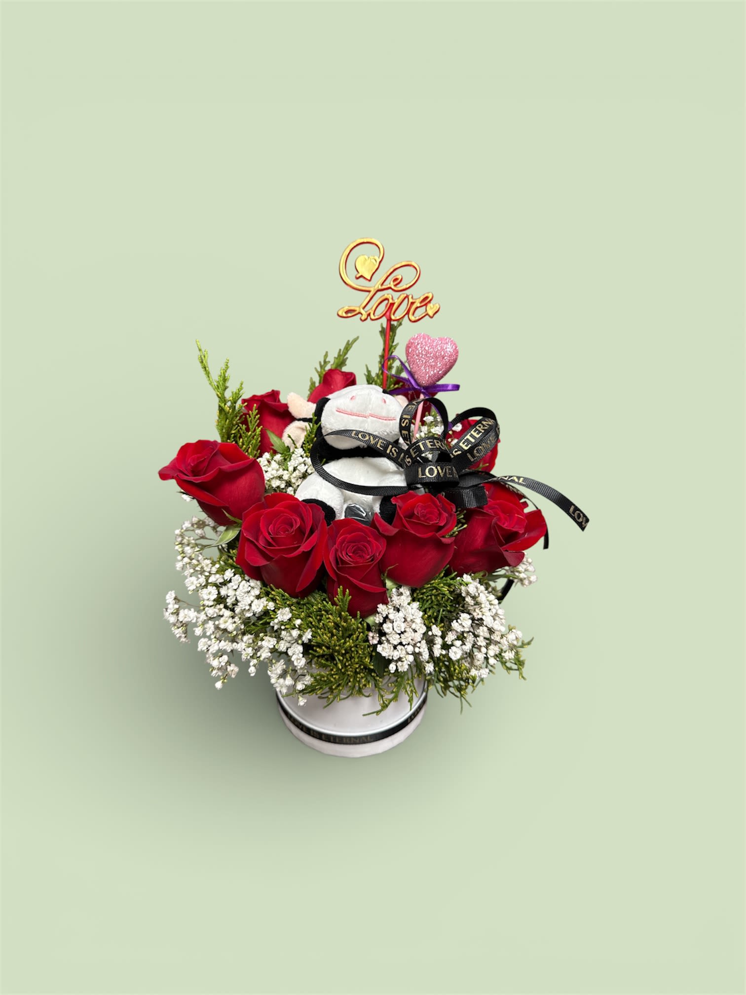 Red roses in a white box with a teddy bear and love topper
