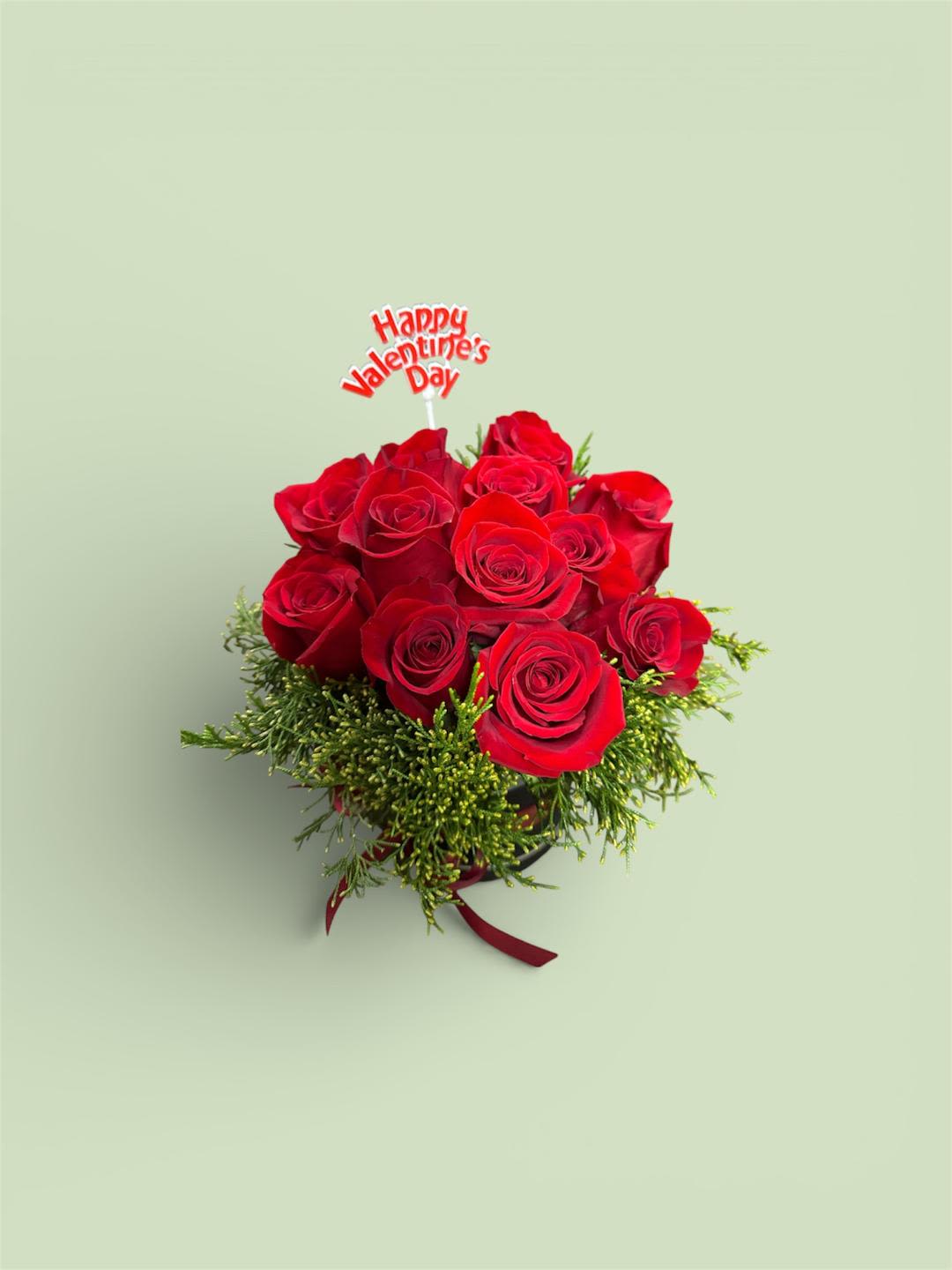 Bouquet of red roses with a Valentine's Day topper