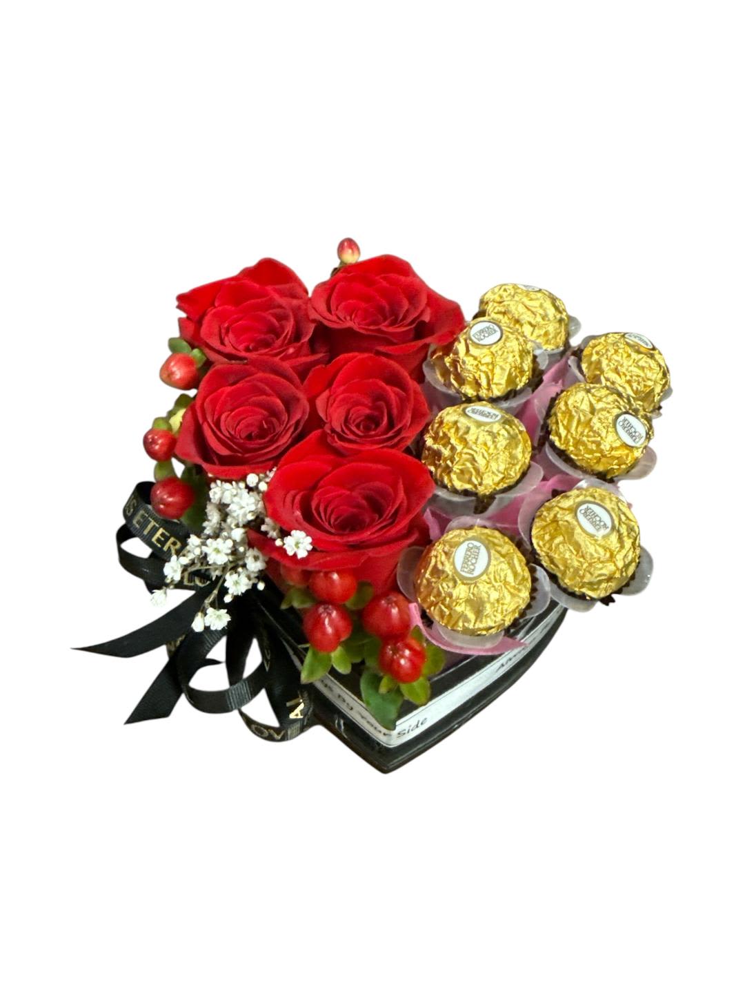 Red roses with gold-wrapped chocolates in a heart-shaped box