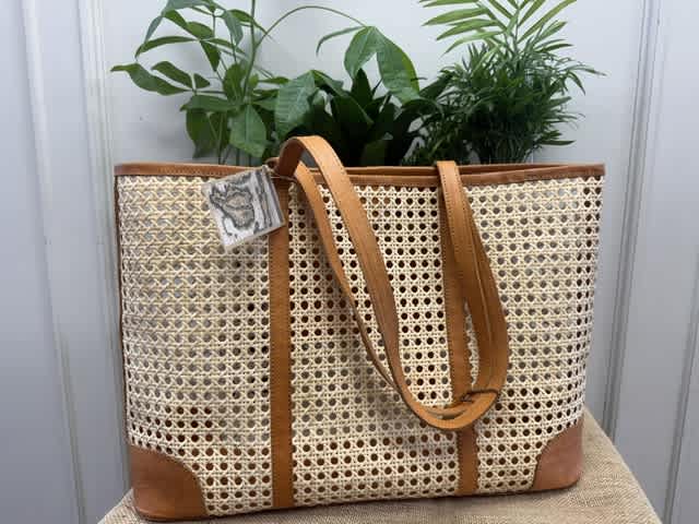 Woven tote bag with tan leather straps and trim